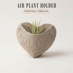 a heart-shaped ceramic planter with a plant growing in it.