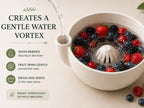 a white bowl filled with a variety of colorful berries, such as strawberries and blueberries, being washed gently in a bowl with water.