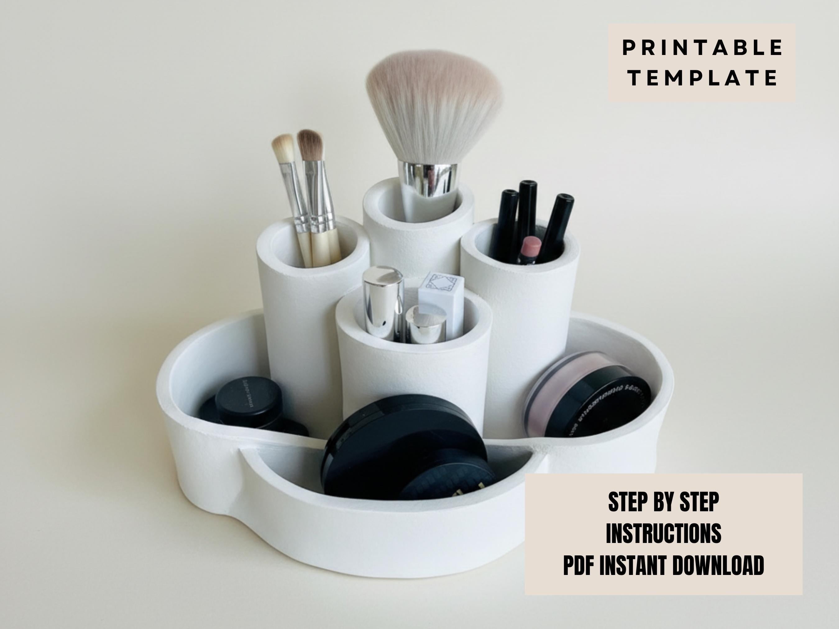 A white makeup organizer with various makeup brushes and containers, including a large brush and multiple smaller ones, arranged in a circular pattern.