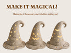 three witch hats with carved designs, including stars, bats, and a jack-o-lantern face, arranged in a row.