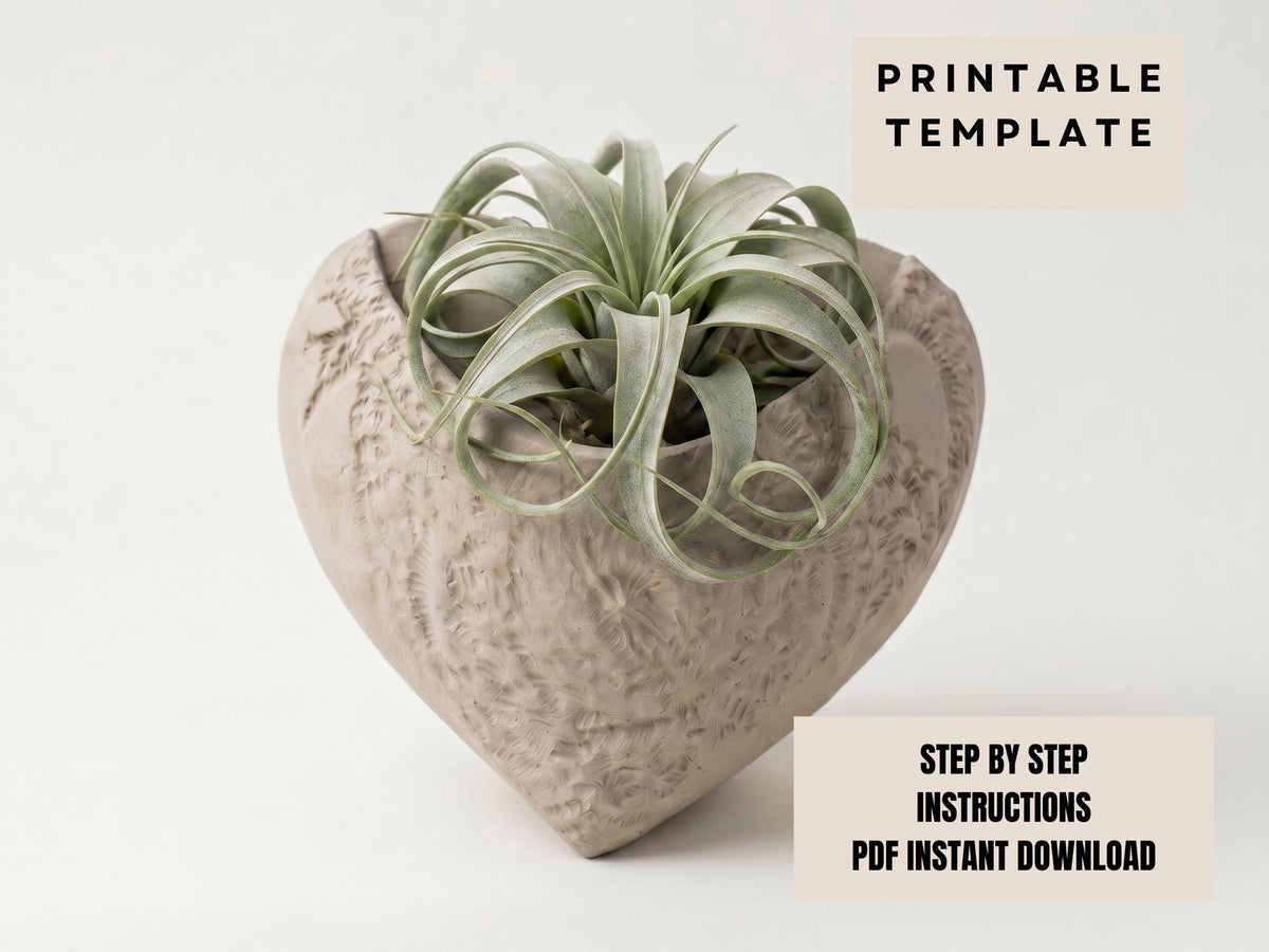 a heart-shaped planter with a plant growing in it.