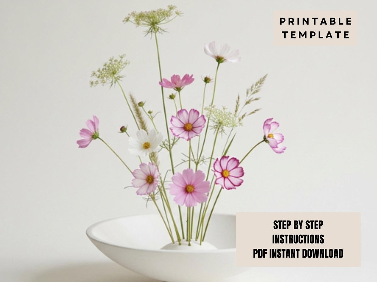 a white bowl filled with a variety of pink and white flowers, including daisies and other types of flowers, placed on a white surface.