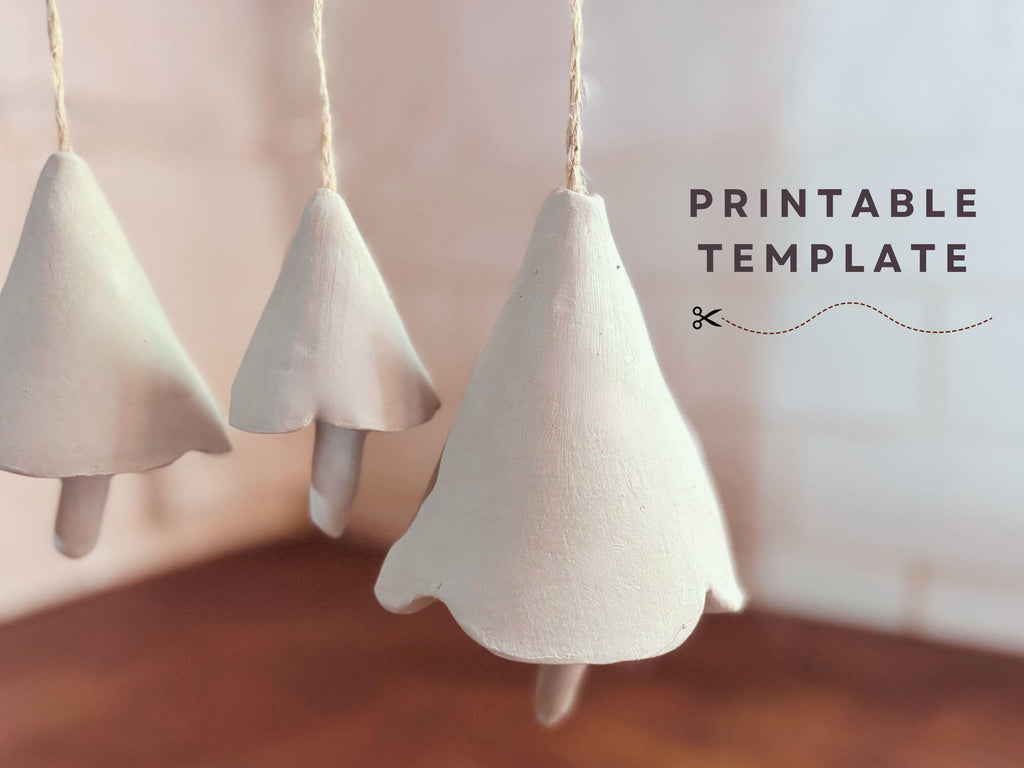 three white ceramic ornaments hanging from strings, with the text "PRINTABLE TEMPLATE" displayed in the background.
