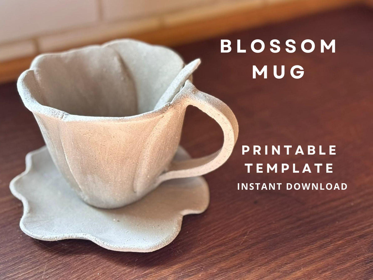Handmade ceramic mug shaped like a flower blossom, with a matching wavy-edged saucer and small spoon. The mug has a textured surface and a natural clay finish, displayed on a wooden countertop. Text overlay reads "Blossom Mug – Step by Step Instructions, PDF Instant Download.