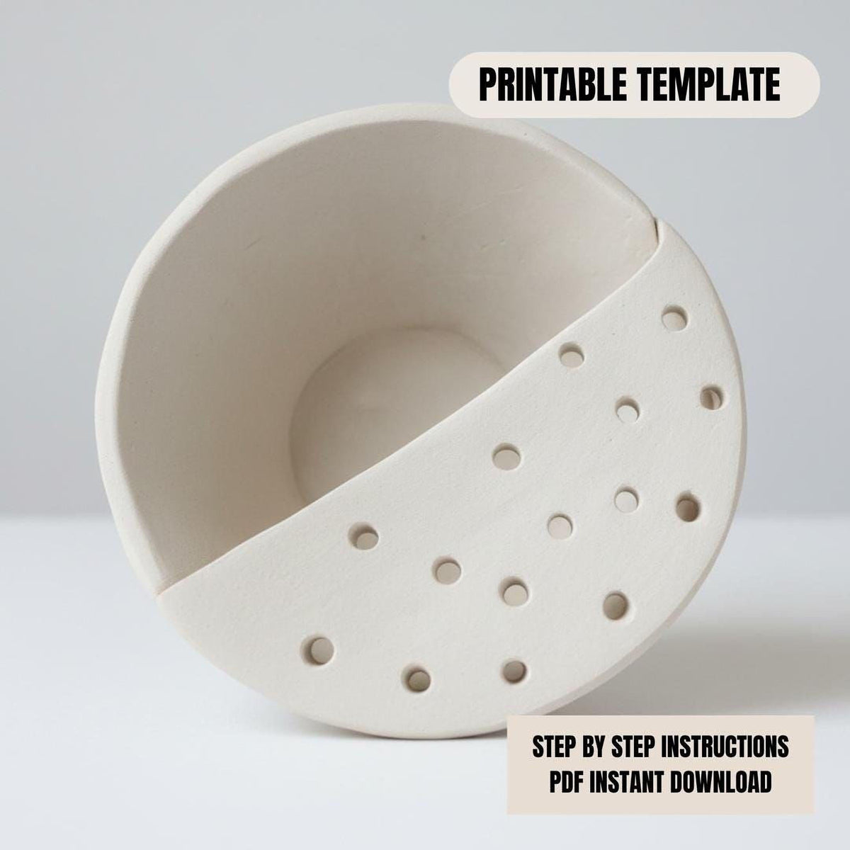 a white ceramic bowl with holes in it, placed on a white surface.