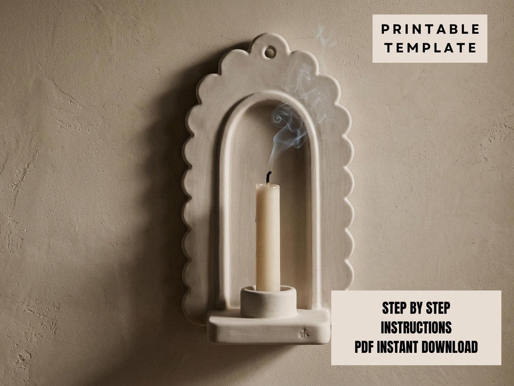 a white candle holder with a lit candle inside, set against a plain beige wall.