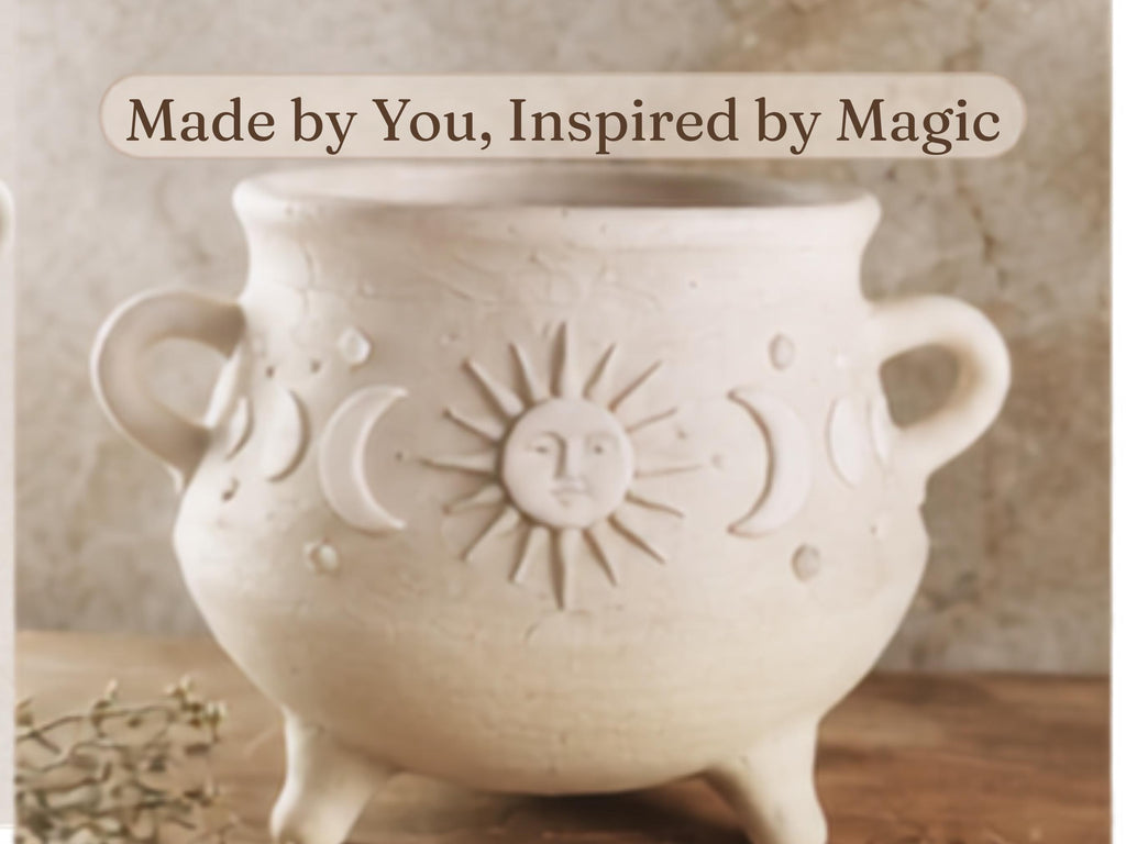 A white ceramic pot with a sun and moon design, sitting on a wooden surface.