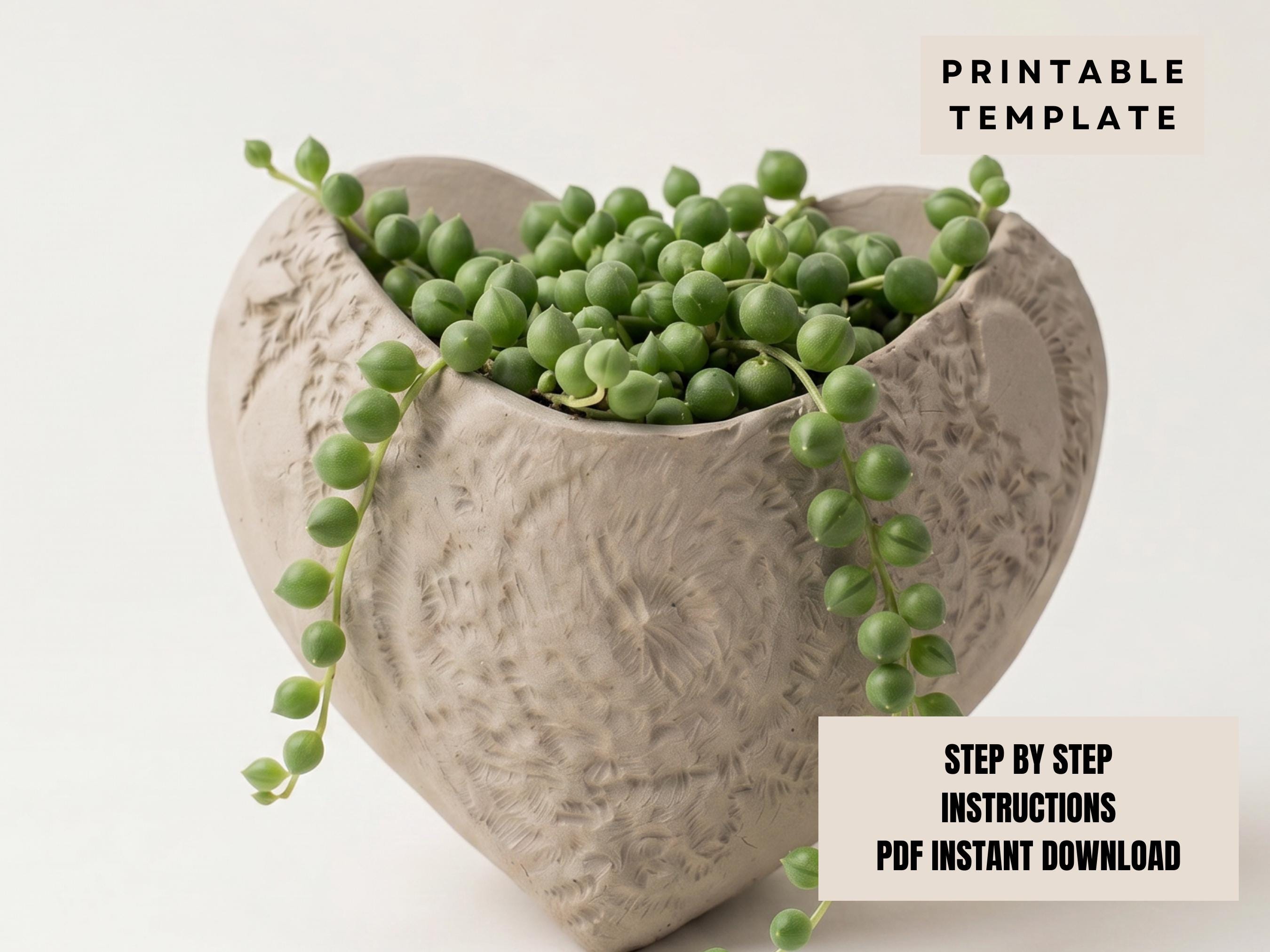 A heart-shaped ceramic planter filled with green pearls or beads, creating a decorative and natural-looking arrangement.