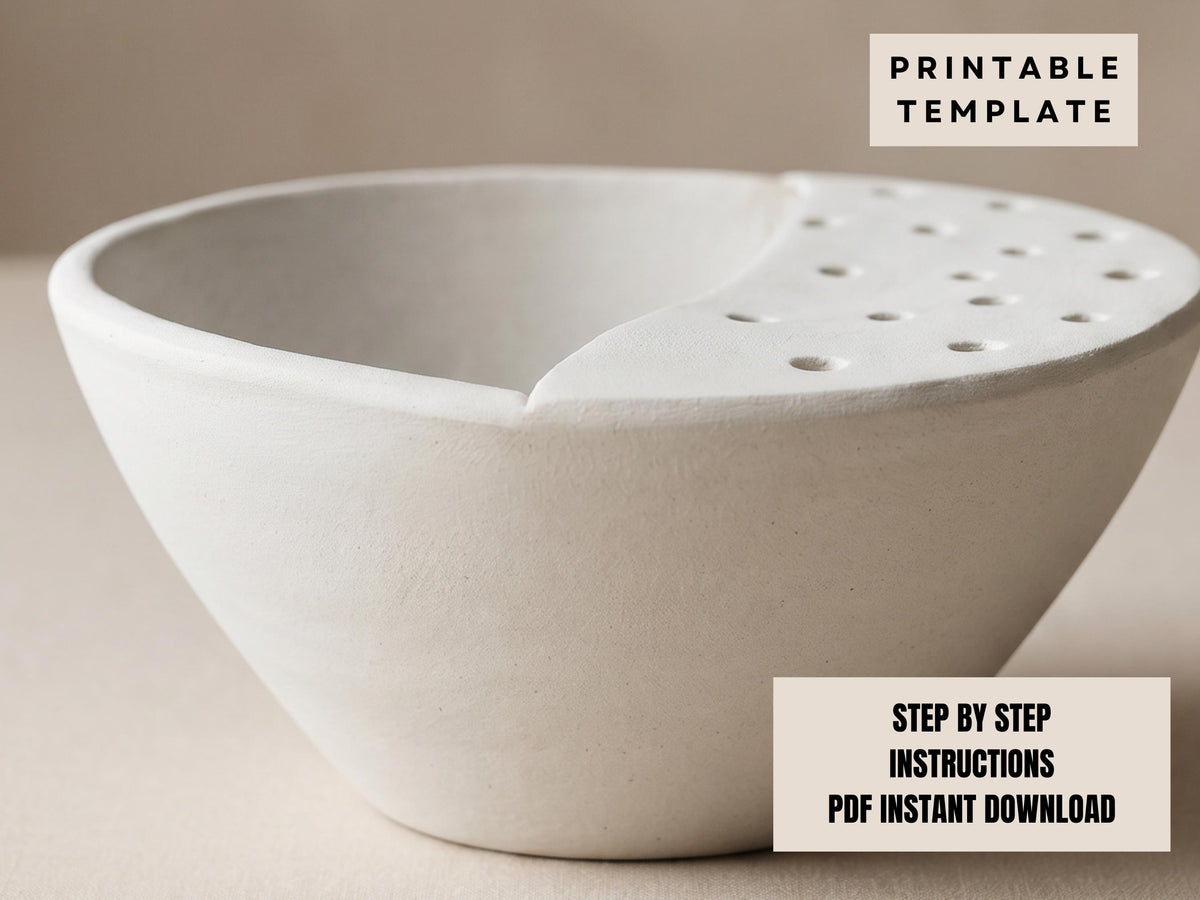 a white ceramic bowl with a hole in the center, sitting on a plain surface.