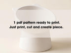 A white ceramic bowl with a text overlay instructing to print a pattern, cut, and create a piece.