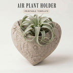 a heart-shaped ceramic planter with a plant growing in it.
