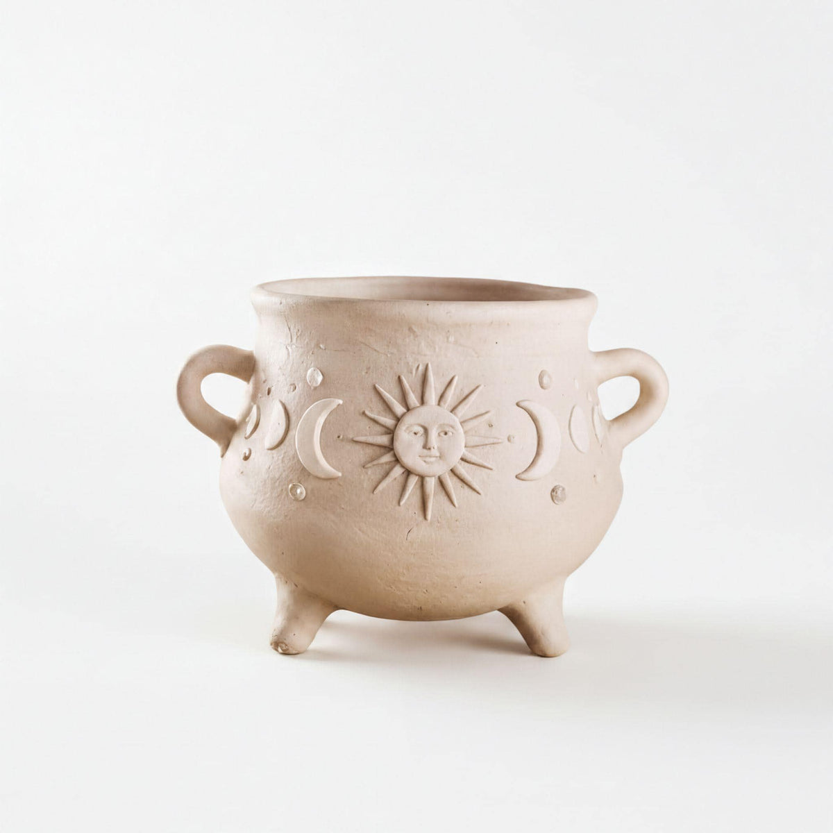 A beige ceramic pot with a sun and moon design on it, sitting on a white background.