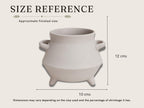 a pottery piece, likely a vase or a bowl, with dimensions provided in cm. The pottery piece appears to be made of a light-colored material, possibly clay. The dimensions are 10 cm in height, 12 cm in width, and 10 cm in depth. The image also includes a reference to the pottery piece being approximately finished, which suggests that it has been crafted and is ready for use.