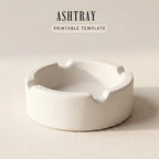 A white ashtray sits on a plain surface.