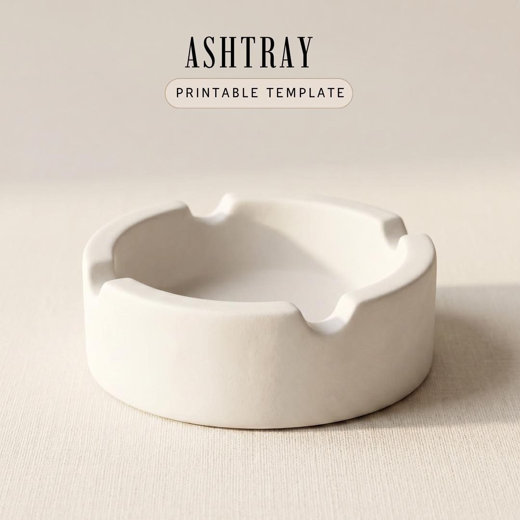 A white ashtray sits on a plain surface.