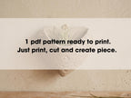 A potted plant with a text overlay instructing to print, cut, and create a piece.