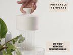 A hand is holding a white object, which appears to be a white vase or container, and it is pouring water from it into a glass or bowl.