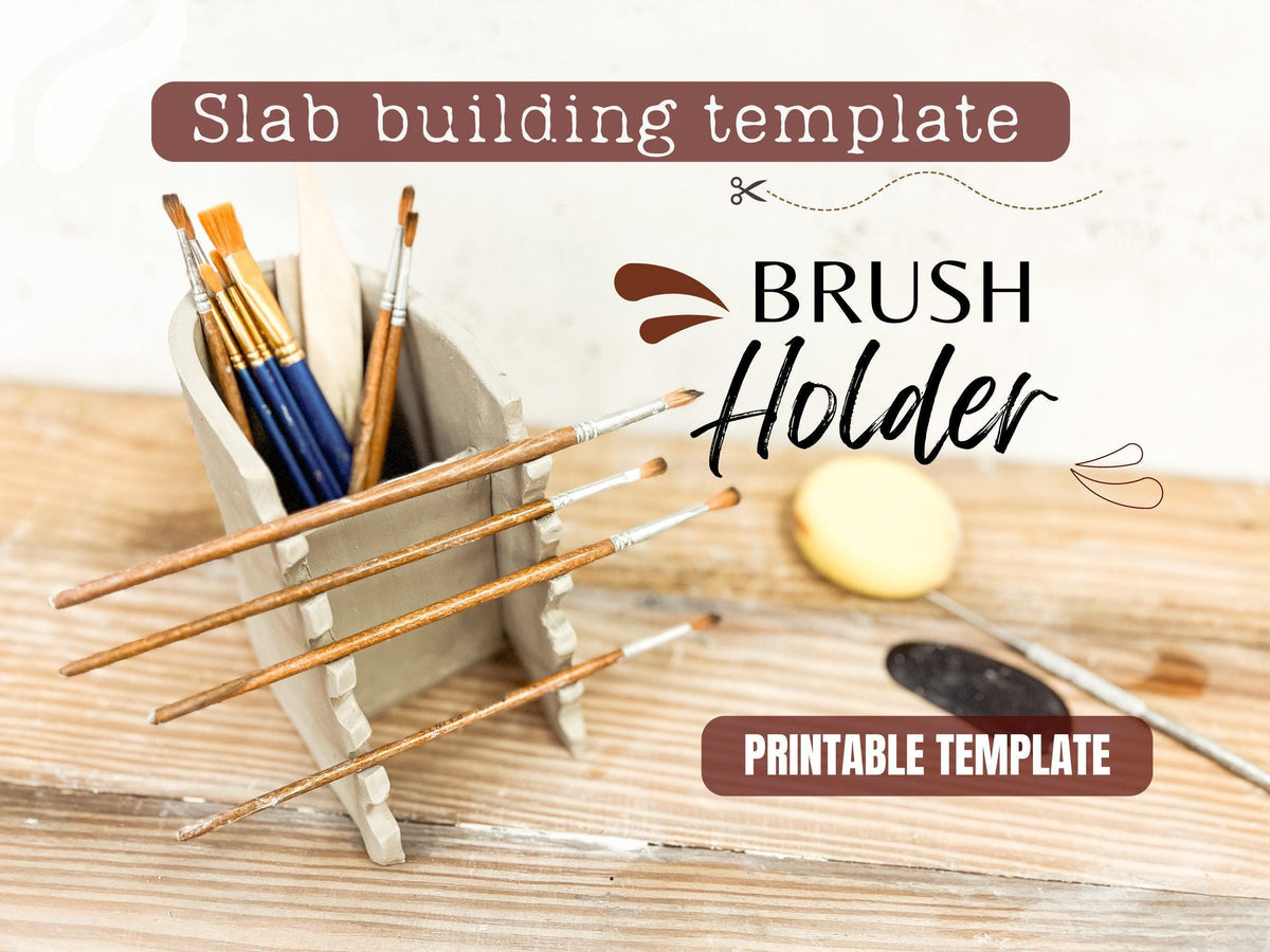 a set of paintbrushes in a wooden holder, along with a brush and a small object on a wooden surface.