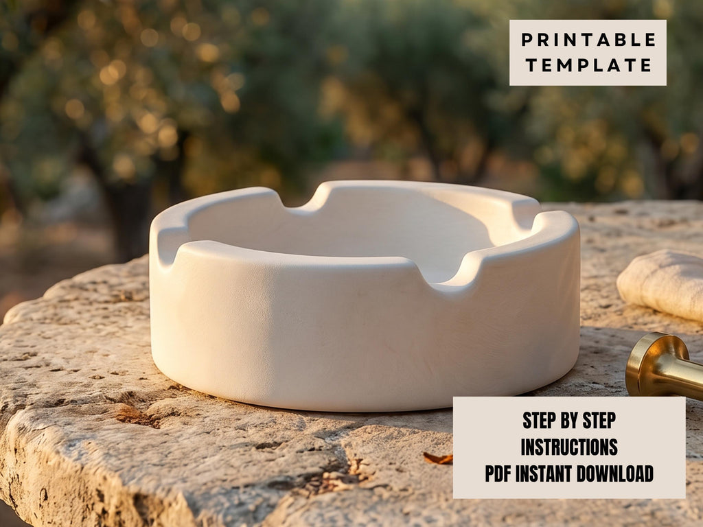 A white ashtray sits on a stone surface, with a blurred natural background.