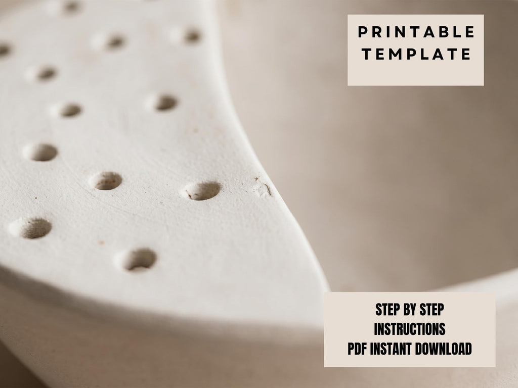 The image is a close-up of a white ceramic object with numerous small holes or perforations on its surface.