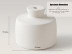 a white ceramic object, possibly a vase or container, with dimensions of 10 cm in length and 10 cm in width.