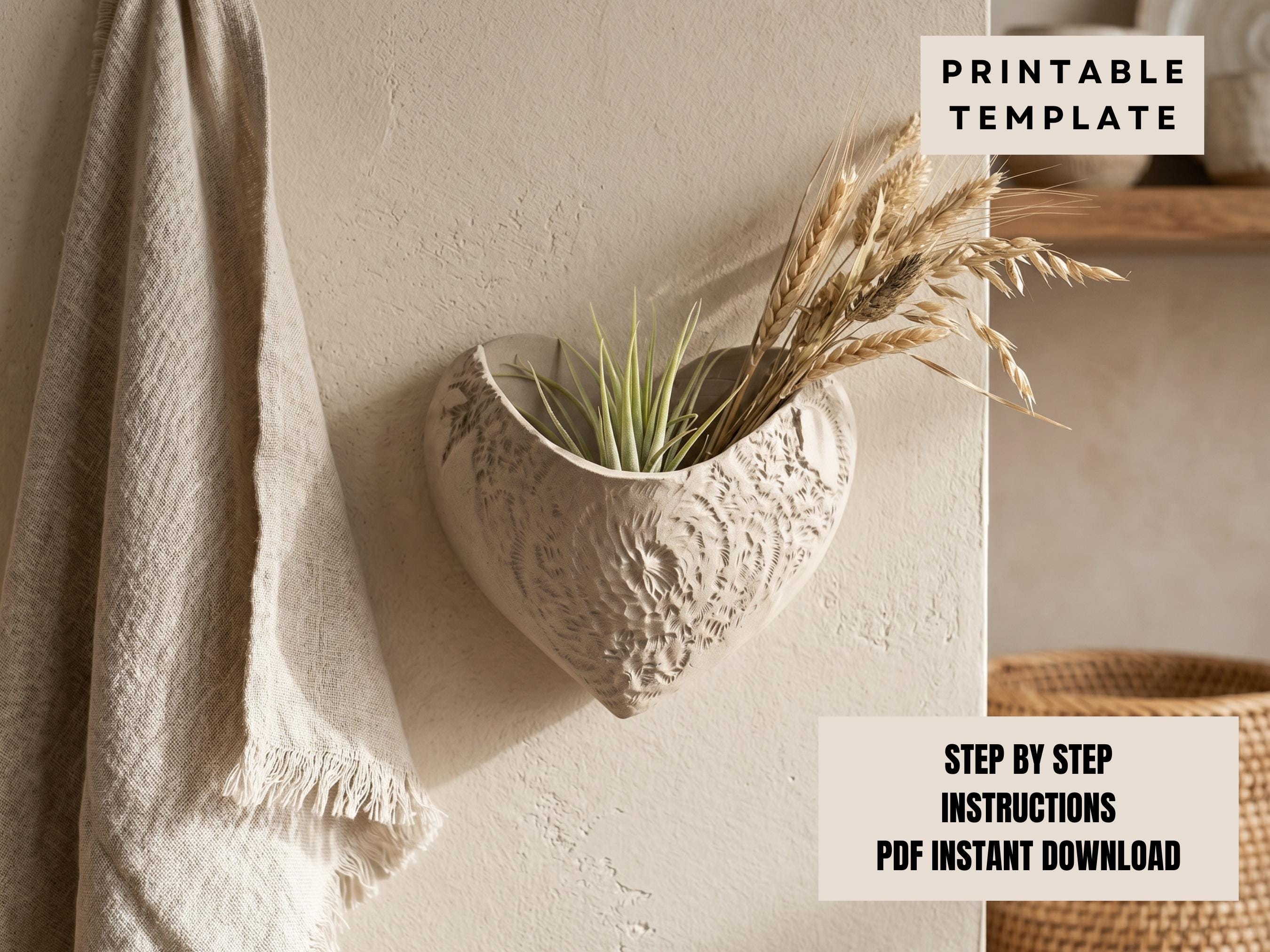 a heart-shaped planter with a plant inside, mounted on a wall. The planter has a decorative design and appears to be made of a light-colored material. There is a towel hanging on the wall next to the planter.