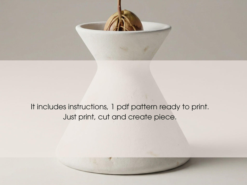 A white ceramic vase with a plant growing in it, accompanied by instructions for creating a similar piece.