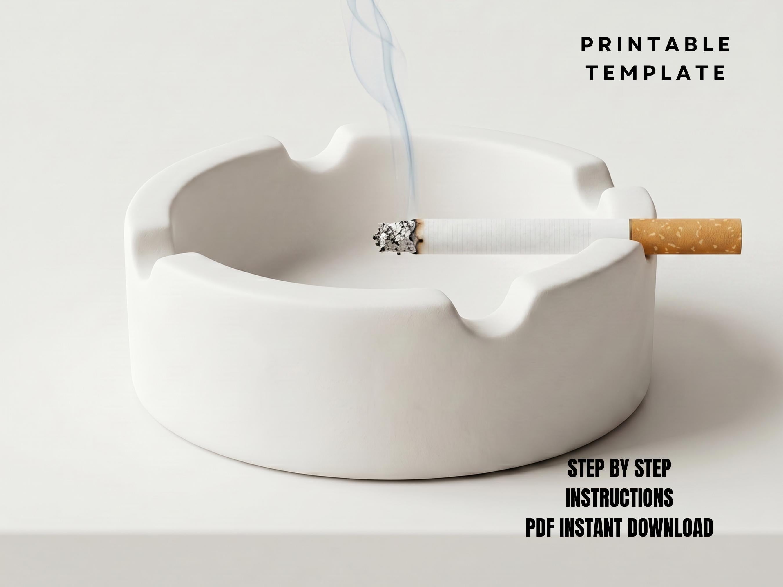 A white ceramic ashtray with a lit cigarette inside, accompanied by a step-by-step instructions for printing a template.