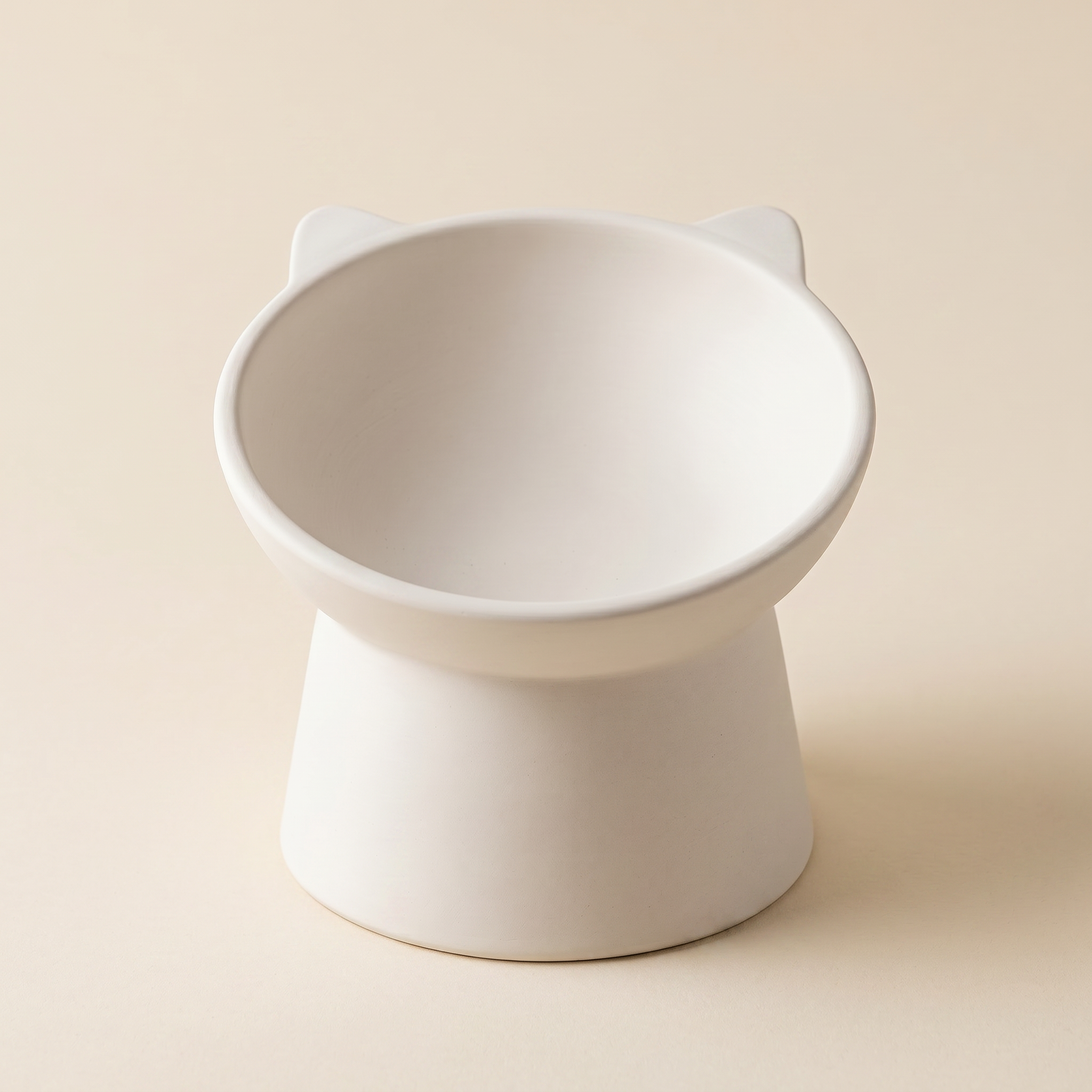 A white ceramic cat food dish with a simple, minimalist design.