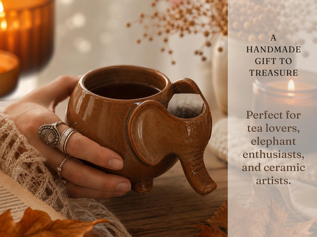 A hand holding a brown ceramic mug with an elephant-shaped design, with a candle and other decorative items visible in the background.