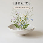 A white ceramic vase filled with a variety of colorful flowers, including daisies and blue flowers, sits on a white surface.