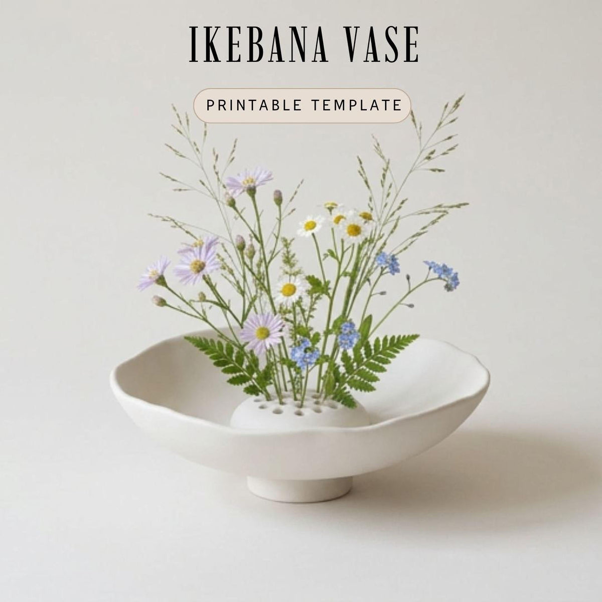 A white ceramic vase filled with a variety of colorful flowers, including daisies and blue flowers, sits on a white surface.