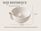 a white ceramic bowl with a small opening on the side, likely used for draining or draining excess water from the clay.
