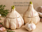 three decorative ceramic garlic bulbs with green shoots growing out of them, placed on a beige surface.