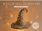 a witch hat with a glowing star design, placed on a brown background.