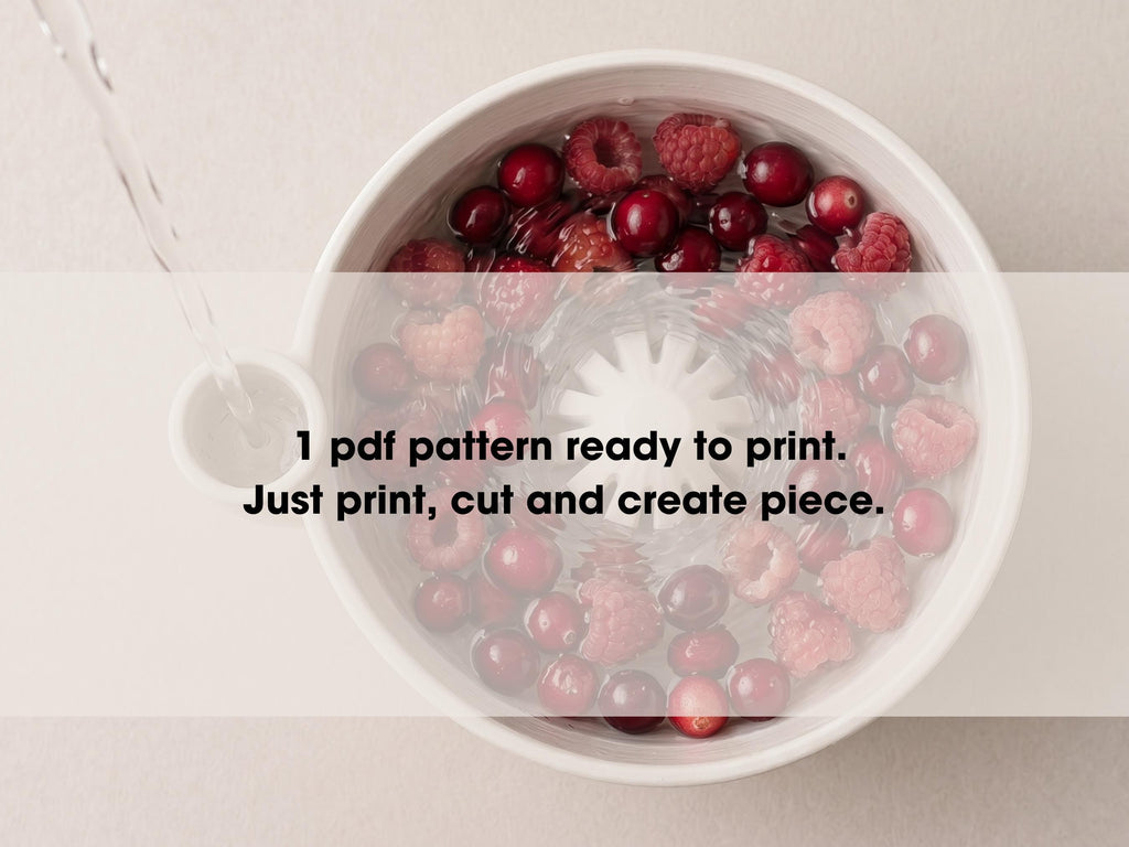 A bowl filled with raspberries and cranberries, with water being poured into it.