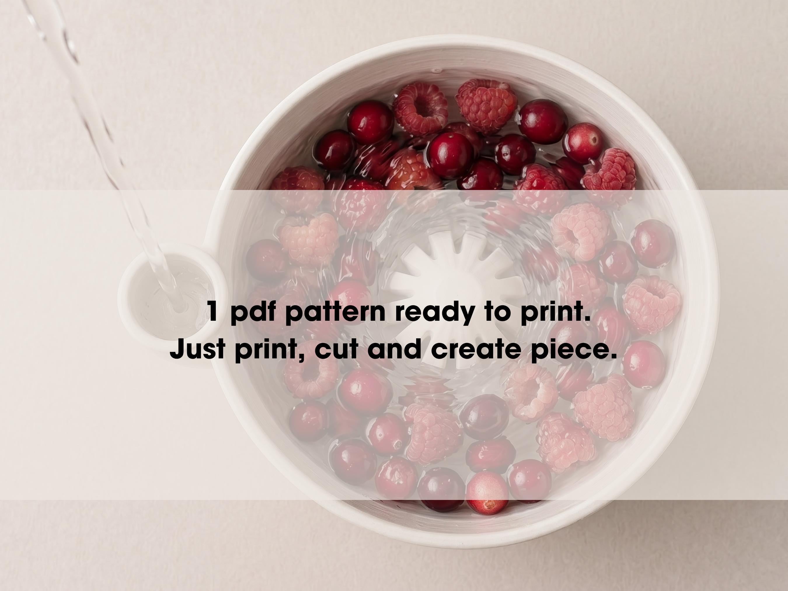 A bowl filled with raspberries and cranberries, with water being poured into it.