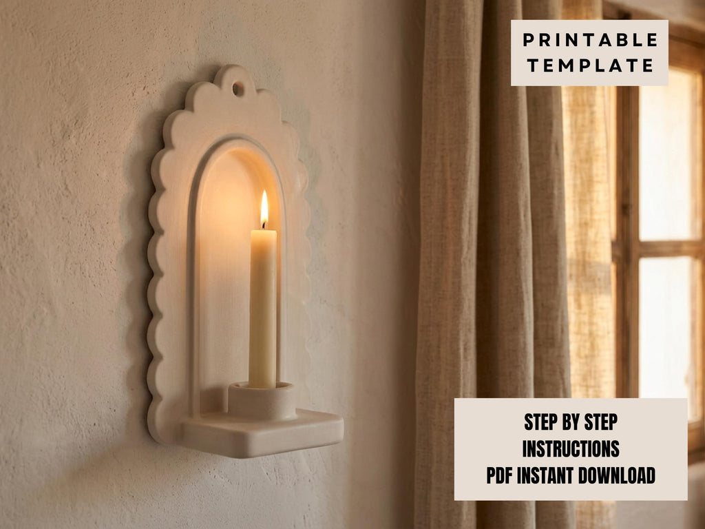 a white candle holder mounted on a wall, with a lit candle inside.