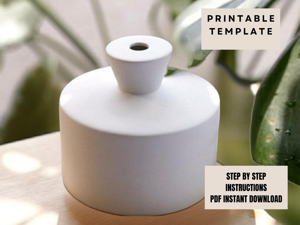 a white ceramic vase with a hole in the center, placed on a wooden surface.